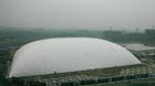 A large tent measuring up to 20,000 square meters is erected over the site of an obsolete pharmaceutical plant in Hangzhou, Zhejiang province, on Tuesday. The soil under the tent is said to be highly toxic.