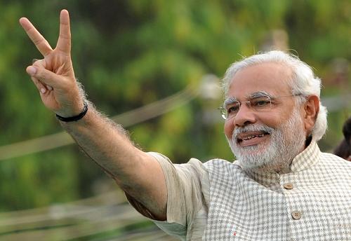 Chief Minister of western Gujarat state and main opposition Bharatiya Janata Party (BJP) prime ministerial candidate Narendra Modi flashes the victory sign as he arrives at a public rally after his victory in Vadodara on May 16, 2014. [Xinhua photo]