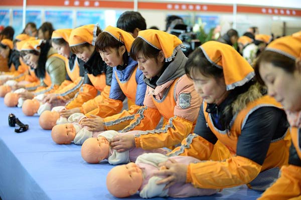 Chinese yue sao - nannies for baby and mother in the first months after birth - show their skills at a job fair in February. Many Chinese want to have a baby during this Year of the Horse, increasing demand for the nannies. [Photo/ Xinhua]
