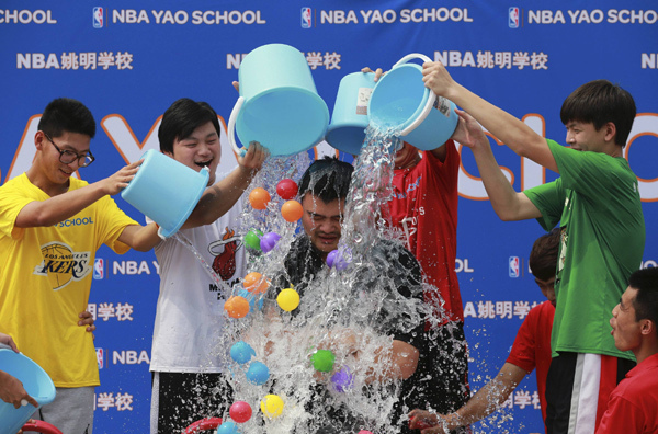 Former NBA star Yao Ming takes the ALS Ice Bucket Challenge on Saturday at the NBA Yao School in Beijing. 