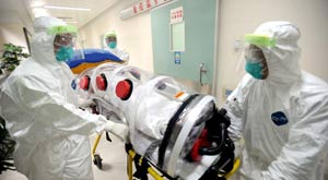 Medical workers take part in a drill to deal with Ebola cases at the Guangzhou Eighth People's Hospital in Guangzhou, capital of south China's Guangdong Province, Oct. 23, 2014.