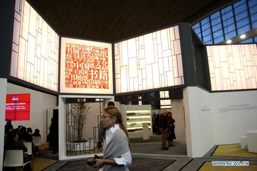 A visitor passes by the section for Chinese books at the 59th Belgrade Book Fair, in Belgrade, Serbia, Oct. 26, 2014. China has taken part in the book fair as host country. [Xinhua]