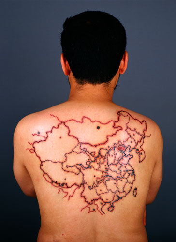 The Miniature Long March-Beijing 2002. Photographs and videos of Qin Ga retrace the Long March, memorializing each site of pilgrimage on the map of China tattooed on his back.