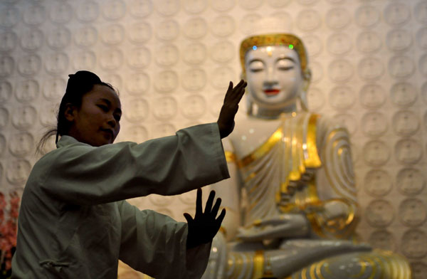A Taoist nun performs Taoist kung fu during a cultural exchange in Paris. Taoism is an ancient tradition of philosophy and religious beliefs based on Chinese customs that emphasize harmony between humanity and the natural world. CHEN XIAOWEI/XINHUA