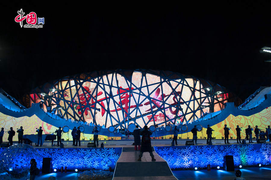 The New Year celebration 'Countdown to 2015' holds its last rehearsal at Beijing's Olympic Park, where the national symbols of the Bird's Nest stadium and the Water Cube National Aquatics Center are located, on Tuesday, Dec. 30, 2014. The ceremony also features the Chinese capital's bidding for the 2022 Winter Olympics. [Photo by Chen Boyuan / China.org.cn]