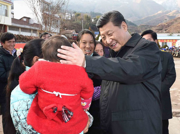 President Xi Jinping chats with quake-hit villagers from Xiaozhai in Ludian county, Yunnan province, on Monday during his first inspection tour of the year. An earthquake in August left at least 617 people dead and 112 others missing. XINHUA