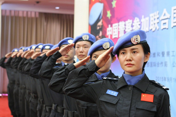 Ye Lixin (front) is among the 12 members of the 14th group of Chinese peacekeeping police officers being sent as part of the United Nations peacekeeping mission in Liberia. The group, which will depart on Thursday for Liberia, held a ceremony in Beijing on Wednesday. [Photo/China Daily]