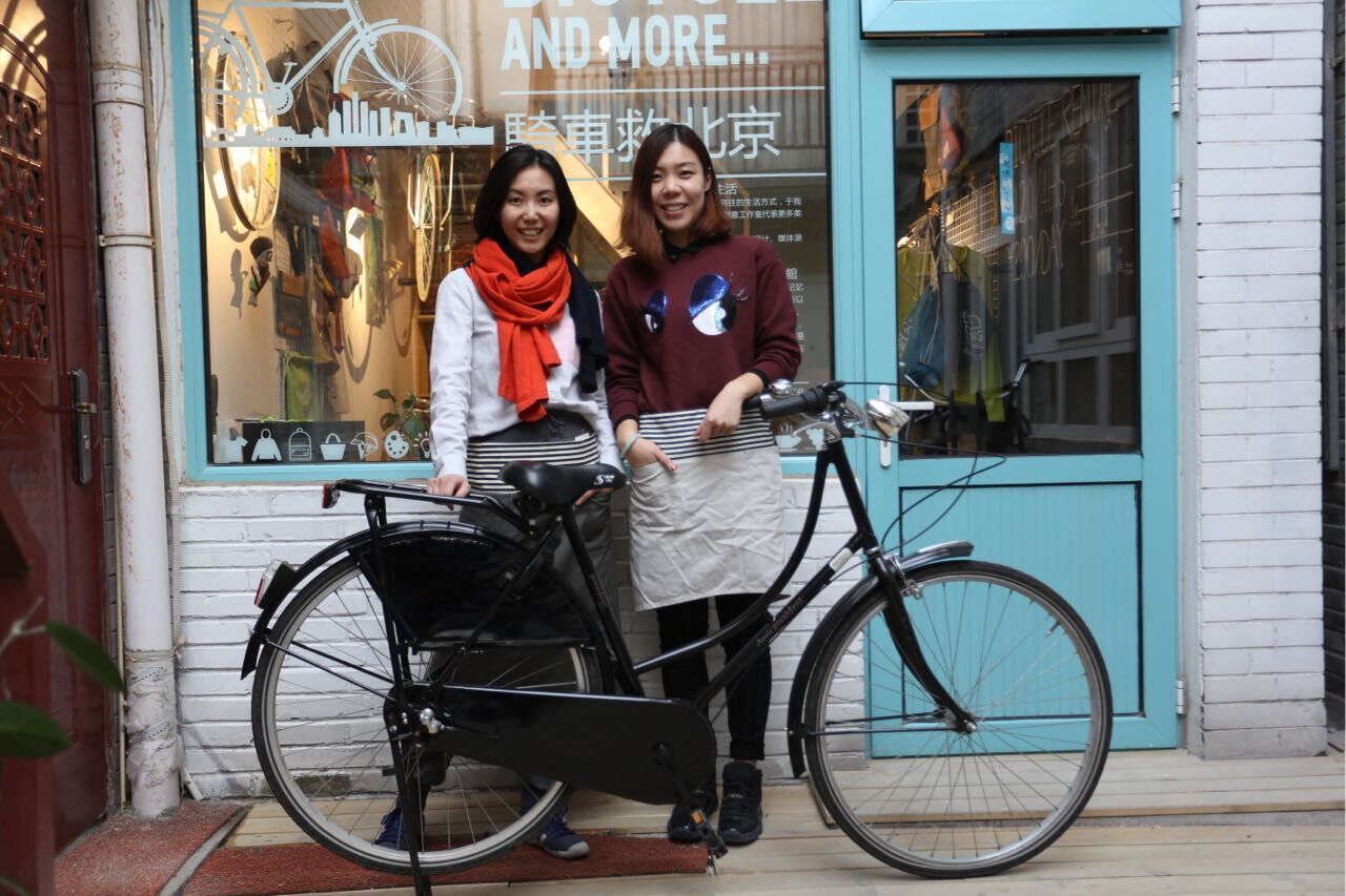 Duan Luo (left) and her business partner Kathy in front of their bike shop in March this year. [Photo: sofat]