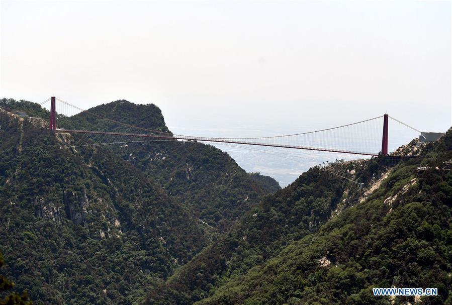 Glass suspension bridge opens in E China