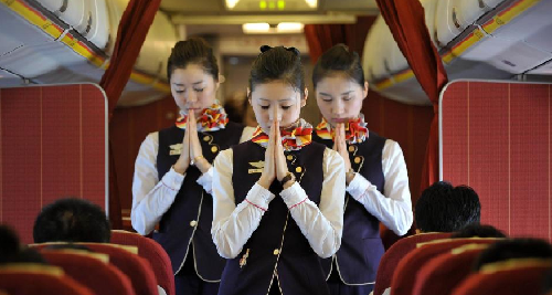 Hainan Airline: Airline hostesses mourn for the quake victims in Yushu prefecture of China’s Northwest Qinghai province on airplane, April 21, 2010.