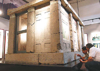 Archaeologists scrutinize the carvings.