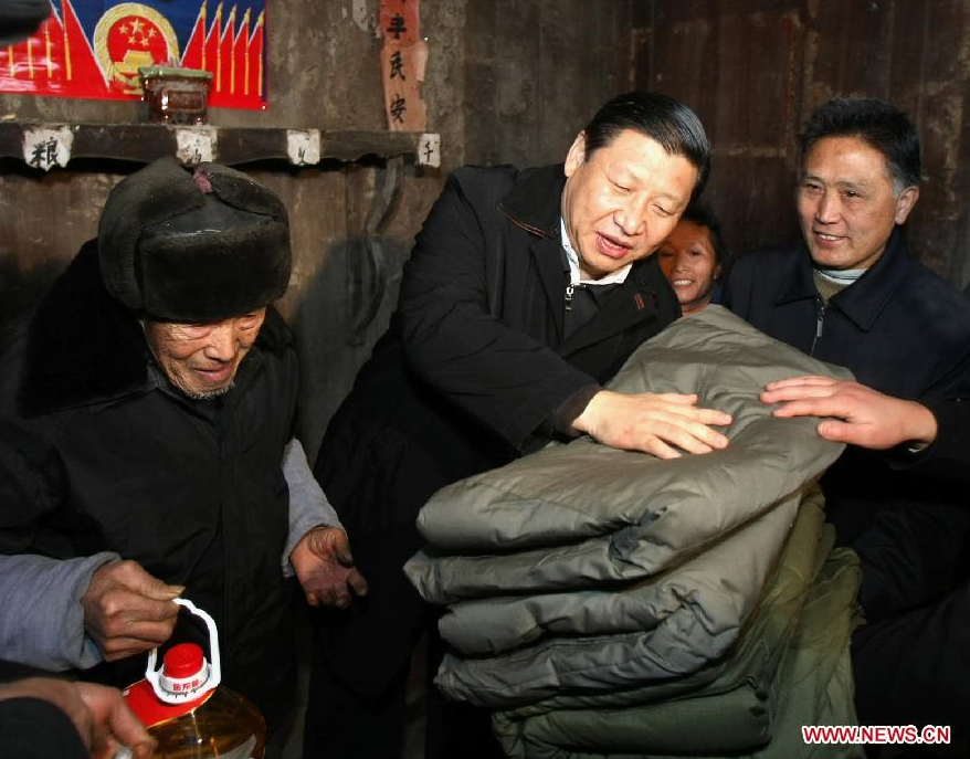 File photo taken in January 2008 shows Xi Jinping (C) visits Tang Zhaowei, a villager of Dong ethnic group who suffered a loss in the snow and ice storms, in Laoshankou Village of Gaolouping Township, southwest China's Guizhou Province. (Xinhua/Lan Hongguang) 