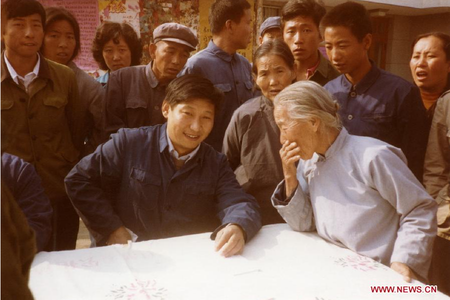 File photo taken in 1983 shows Xi Jinping (L, front), then secretary of the Zhengding County Committee of the Communist Party of China (CPC), listens to opinions of villagers in Zhengding County, north China's Hebei Province.[Photo/Xinhua]